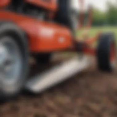 Mower box blade in action on a landscaped field, leveling the soil.